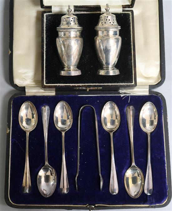 A cased set of six silver teaspoons and tongs, Sheffield, 1921 and a cased pair of silver pepperettes, Birmingham, 1934, 6.4 oz.